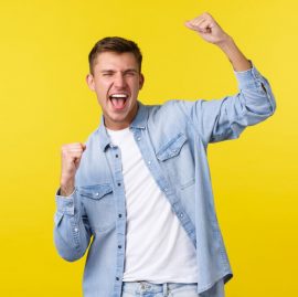 lifestyle-people-emotions-and-summer-leisure-concept-enthusiastic-handsome-happy-man-raising-hands-up-chanting-and-shouting-yes-as-winning-triumphing-over-lottery-prize-yellow-background